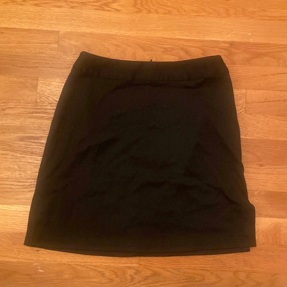 Old Navy Simple Black Skirt. Goes to about mid thigh. Small slits on both sides.
